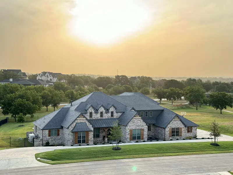Brick home with F-Wave synthetic shingles and standing seam accents