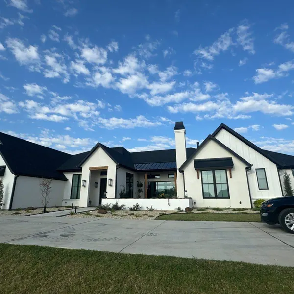 Modern white farmhouse with black roofing