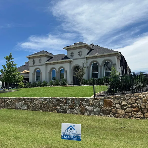 Large stucco estate with a new roof