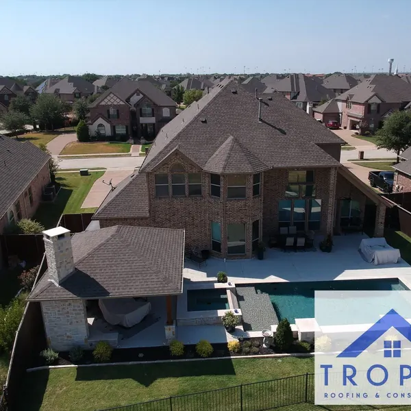 Aerial view of a new roof on a backyard pool home