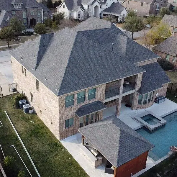 Aerial view of a two-story home with pool and new roof