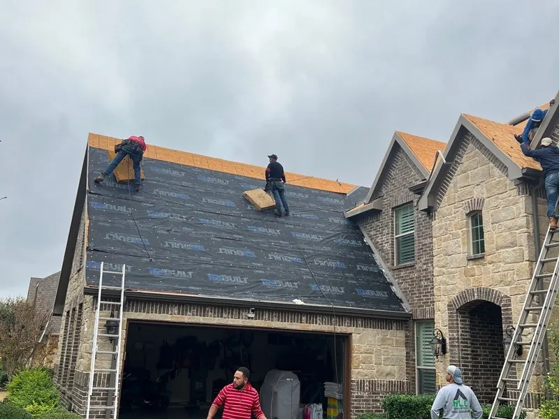 Trophy crew tearing off and re-roofing a stone home